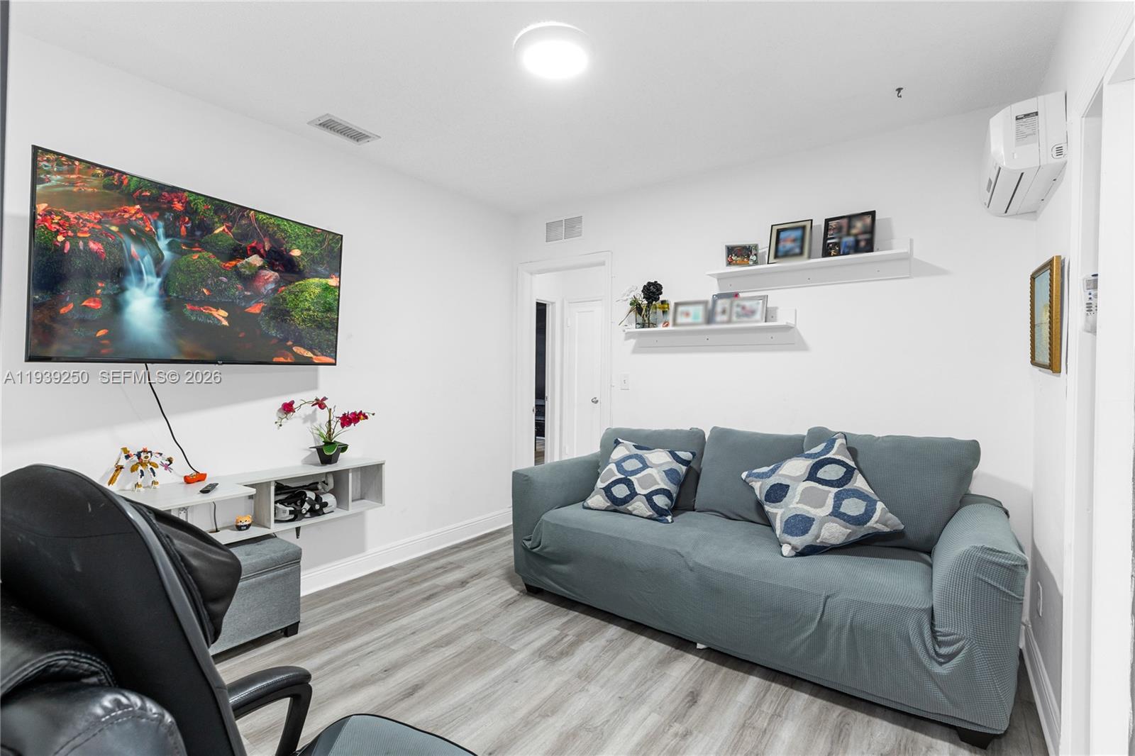 116 East 59th Street Hialeah, FL 33013 - Photo 43 of 51 a living room with furniture and a flat screen tv