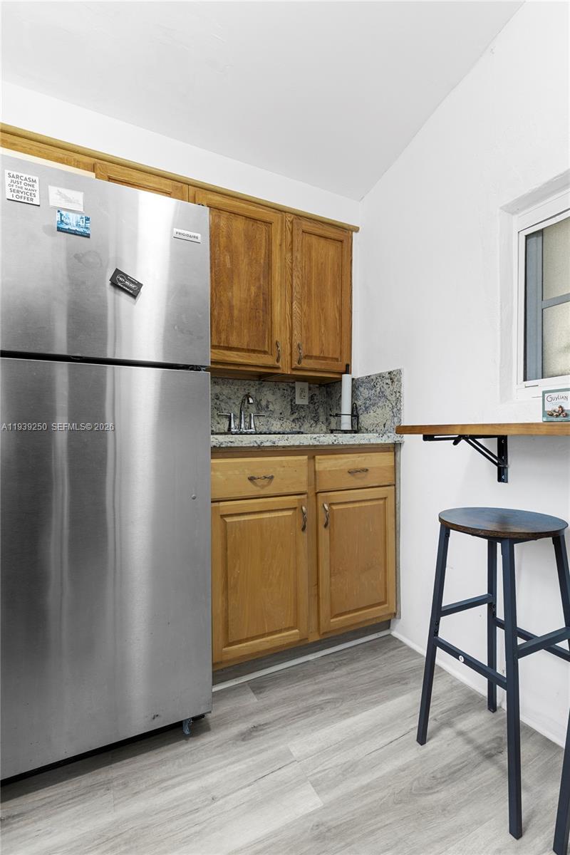 116 East 59th Street Hialeah, FL 33013 - Photo 44 of 51 a kitchen with stainless steel appliances granite countertop a refrigerator a sink and white cabinets