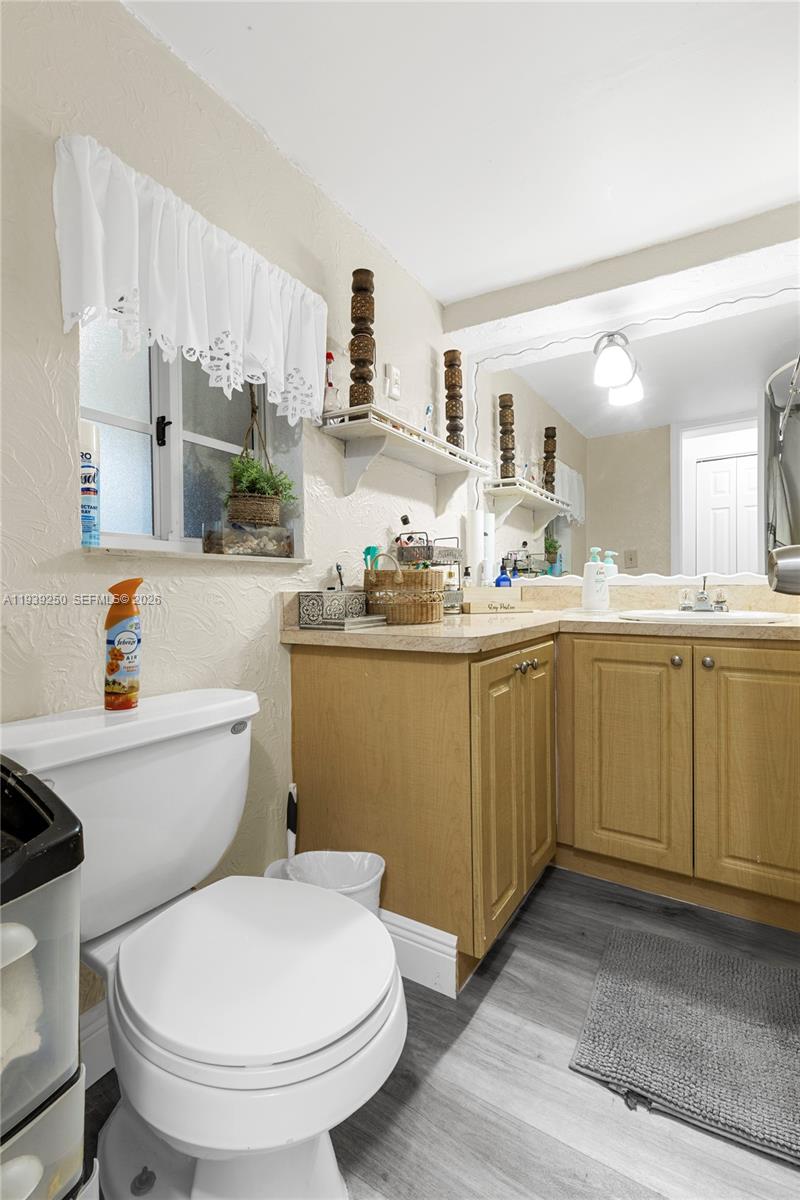116 East 59th Street Hialeah, FL 33013 - Photo 45 of 51 a bathroom with a sink a toilet and a mirror