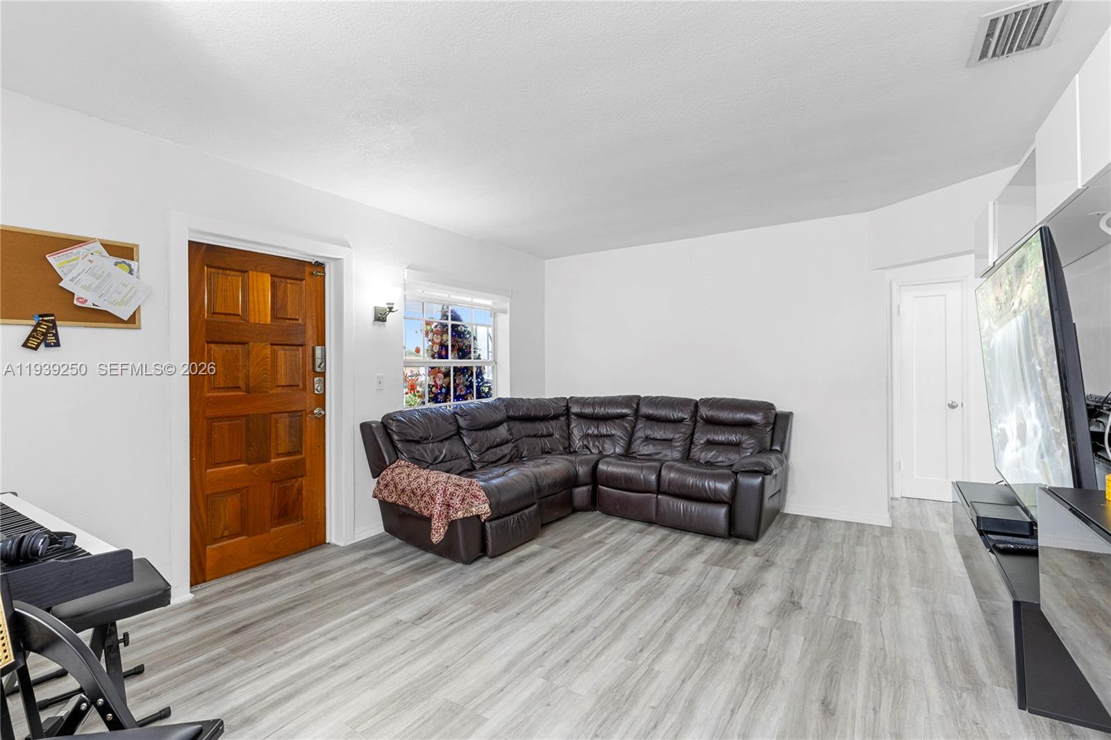 116 East 59th Street Hialeah, FL 33013 - Photo 50 of 51 a living room with furniture and a flat screen tv