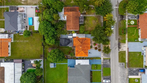 an aerial view of a house with a yard basket ball court and outdoor seating
