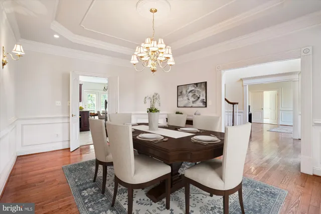 a spacious bedroom with a balcony a bed and a chandelier