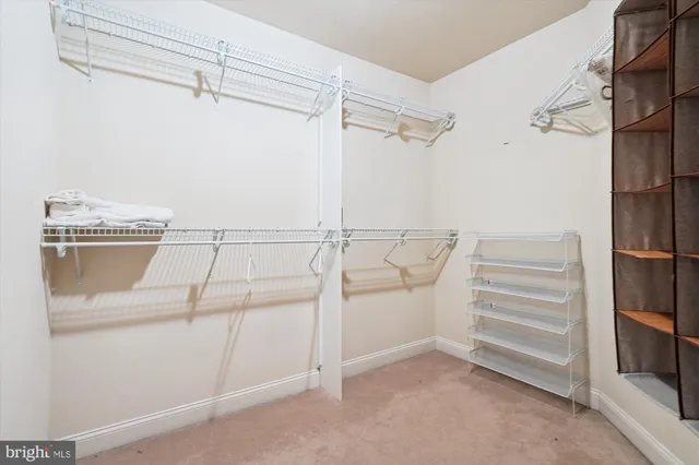 an empty room with a window and a ceiling fan