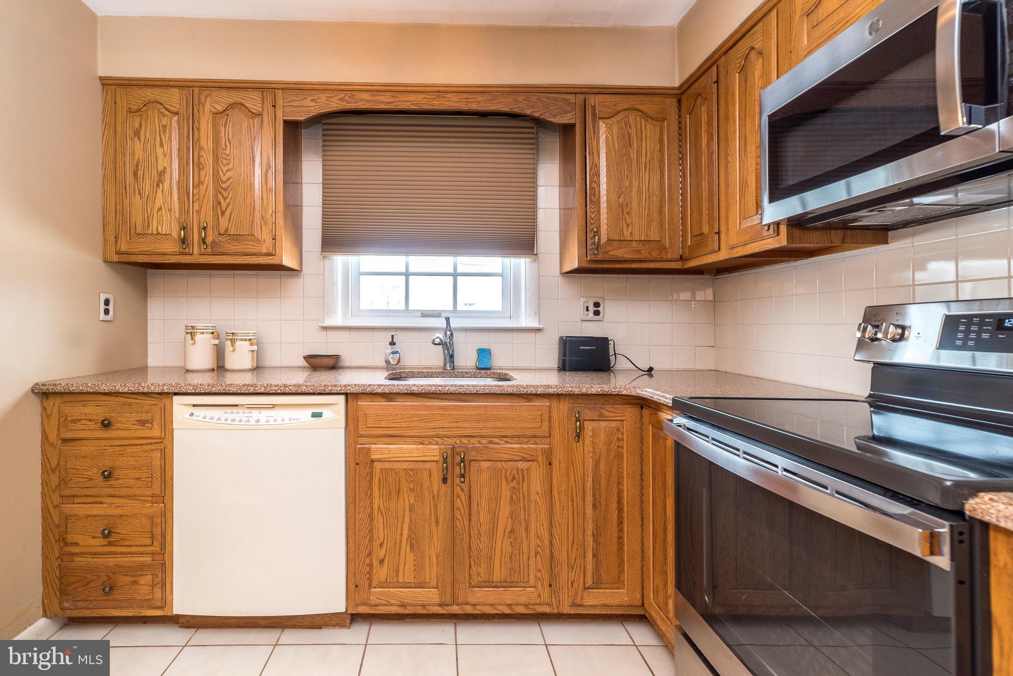 364 Abrams Mill Road King of Prussia, PA 19406 - Photo 17 of 43 a kitchen with stainless steel appliances granite countertop wooden cabinets a stove top oven a sink and dishwasher