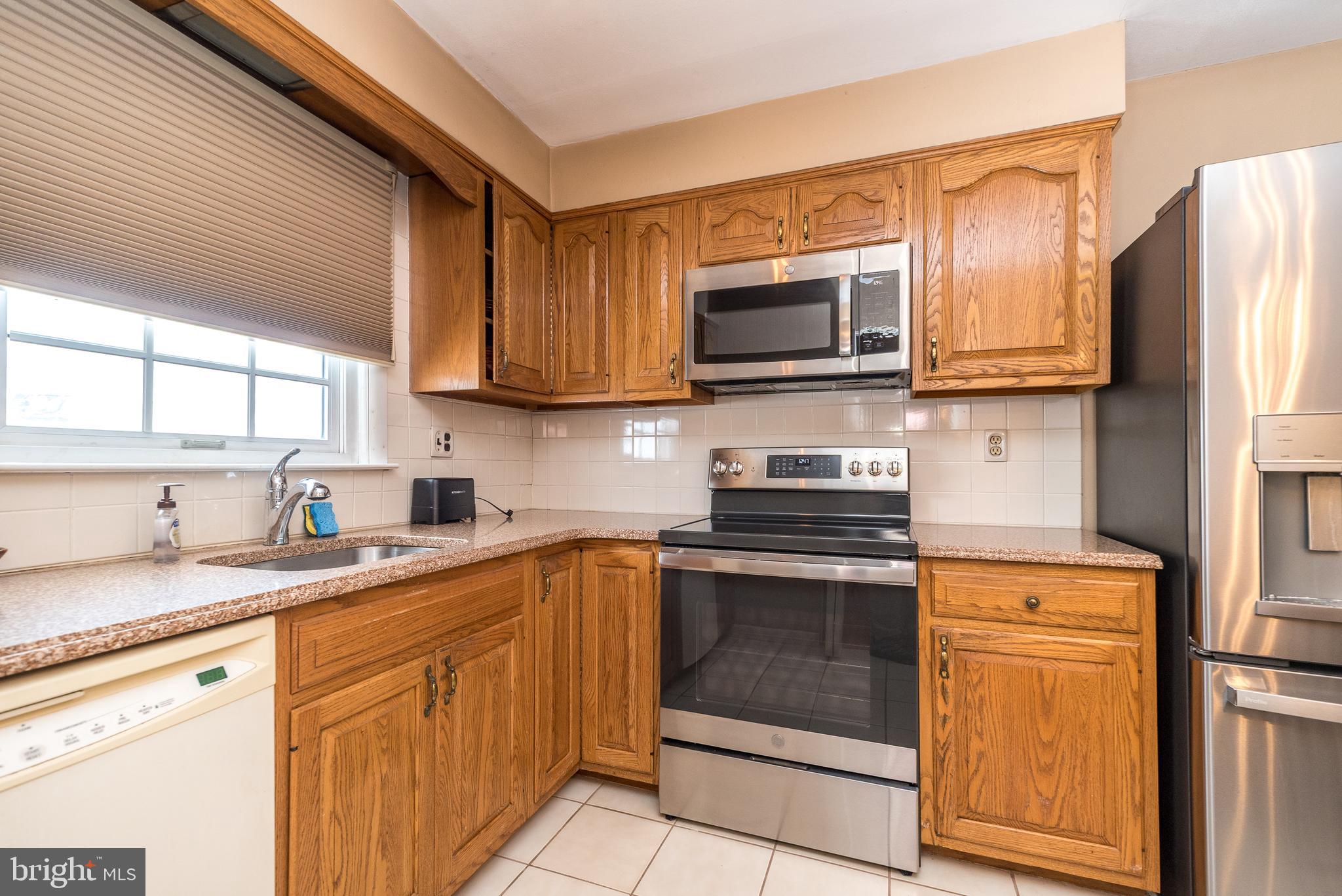 364 Abrams Mill Road King of Prussia, PA 19406 - Photo 18 of 43 a kitchen with stainless steel appliances granite countertop a stove sink microwave and refrigerator