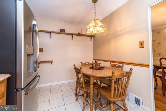 a view of a dining room with furniture and a chandelier