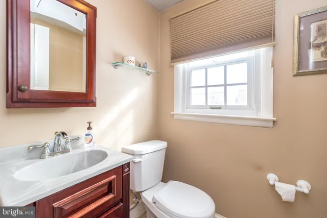 a bathroom with a sink mirror and toilet