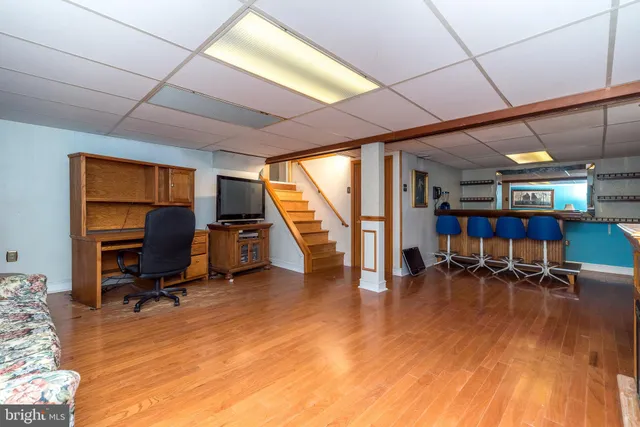 a view of a livingroom with workspace and a window