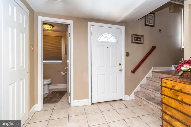 a view of a hallway to a livingroom with furniture and an entryway