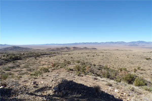 a view of a large mountain with a mountain in the background