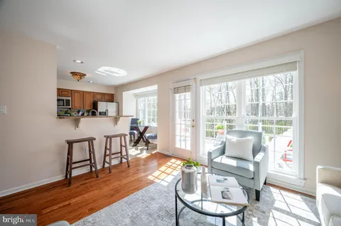 a living room with furniture and a kitchen view