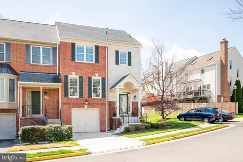 a view of a white house with a large windows next to a road