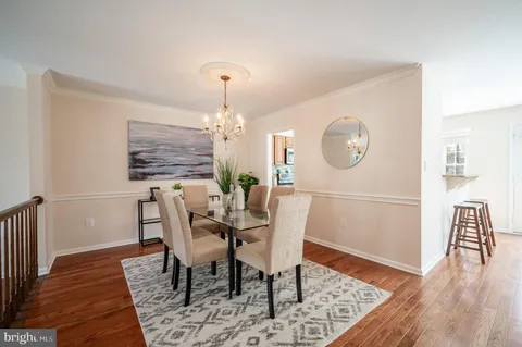 a dining room with furniture a rug and wooden floor