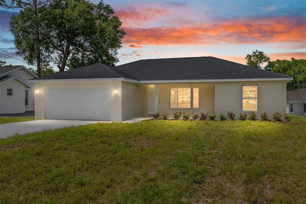 13031 Northeast 7th Loop Silver Springs, FL 34488 - Photo 1 of 34 a house view with a garden space