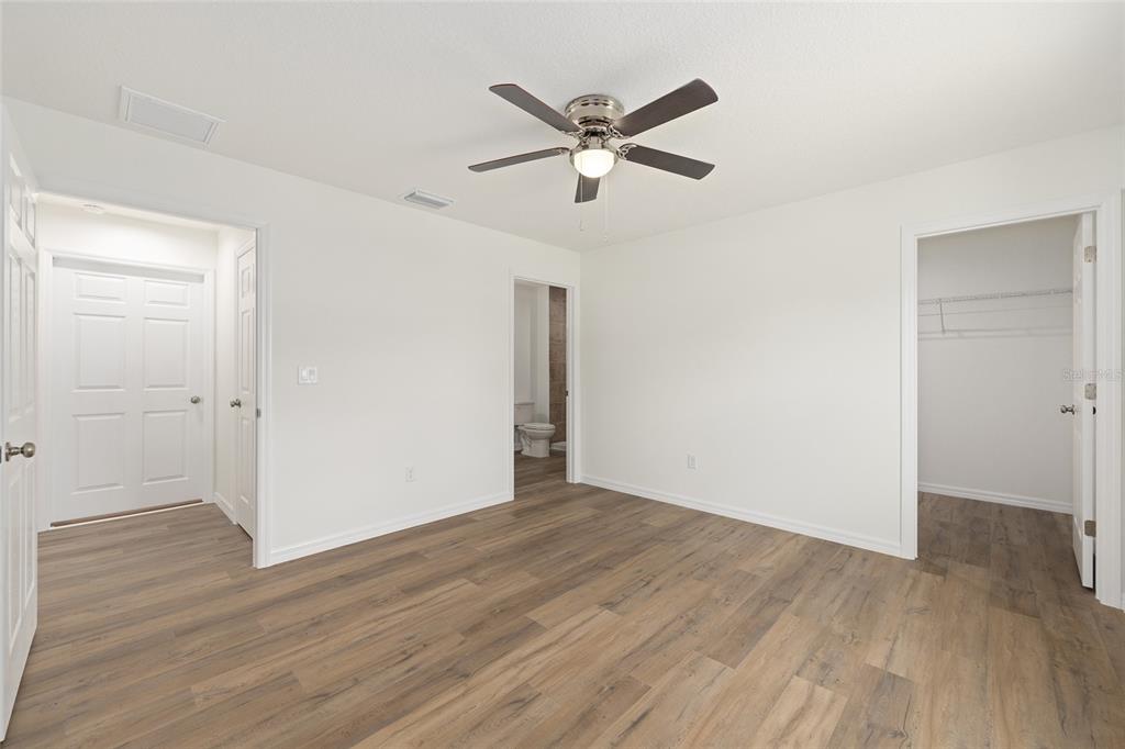 13031 Northeast 7th Loop Silver Springs, FL 34488 - Photo 21 of 34 a view of an empty room with wooden floor