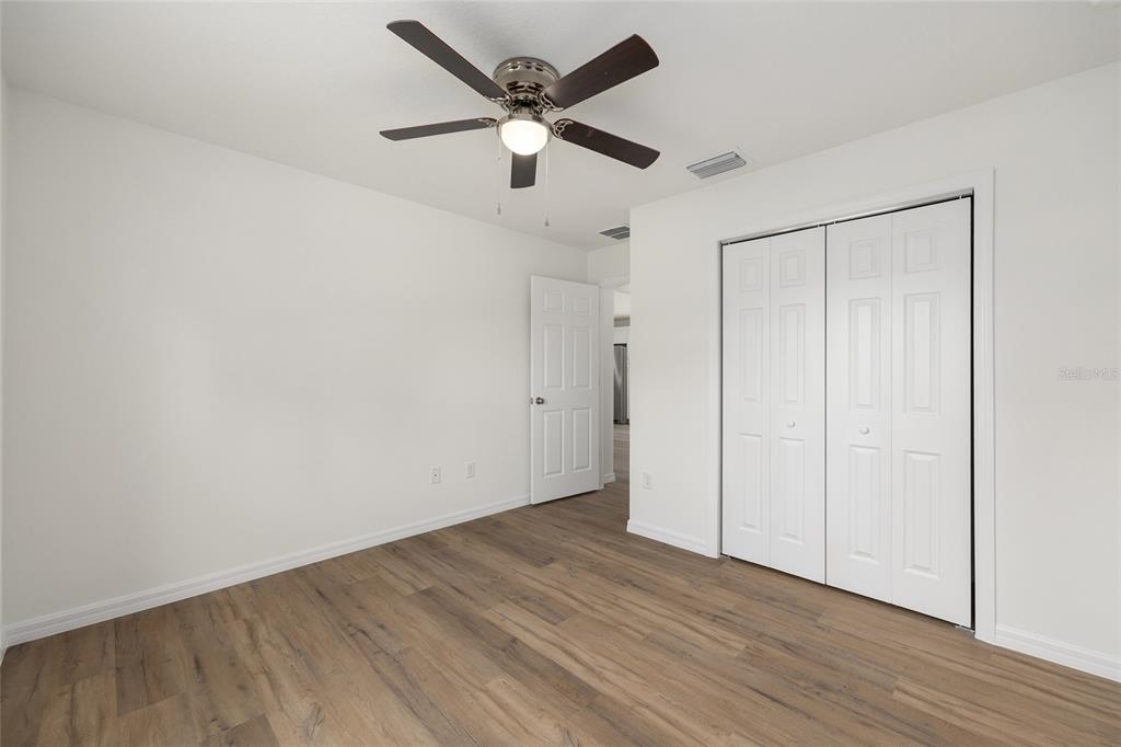 13031 Northeast 7th Loop Silver Springs, FL 34488 - Photo 25 of 34 a view of an empty room with wooden floor
