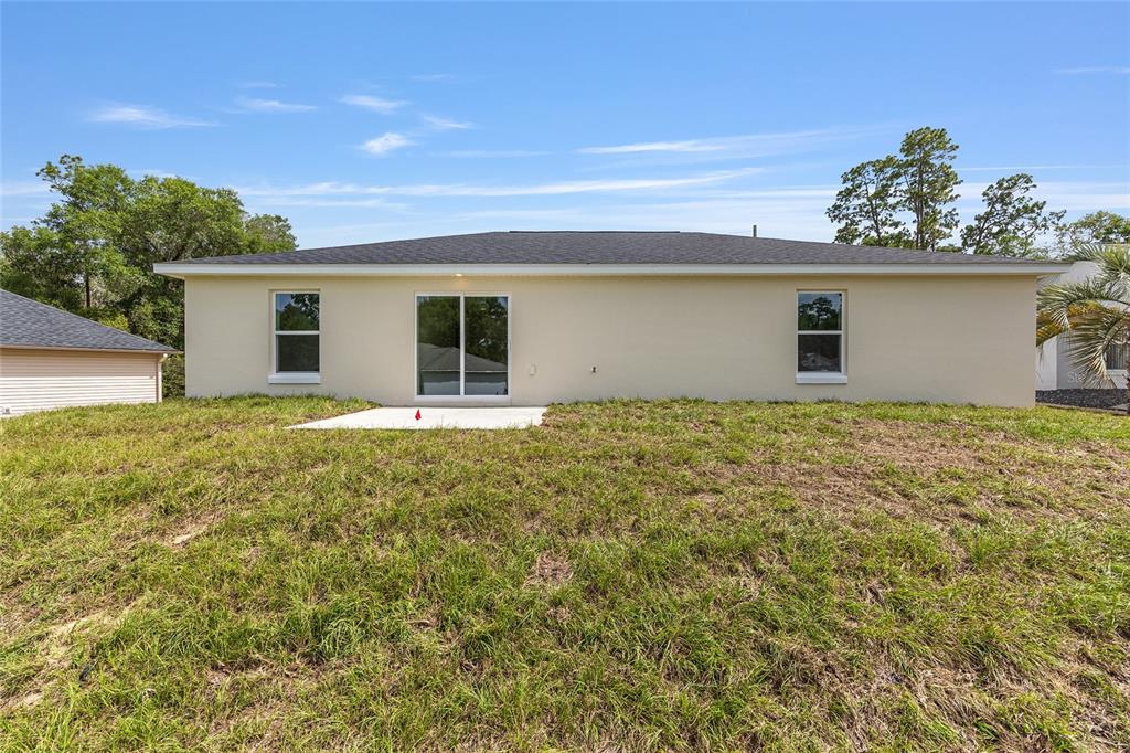 13031 Northeast 7th Loop Silver Springs, FL 34488 - Photo 33 of 34 a view of a house with a yard and potted plants