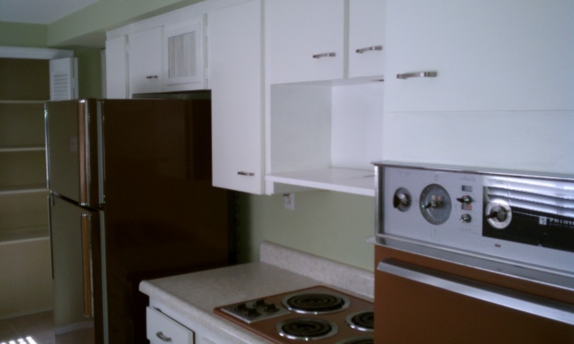 3242 East Camelback Road, Unit 108 Phoenix, AZ 85018 - Photo 4 of 13 a kitchen with a refrigerator and a stove top oven