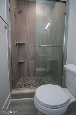a bathroom with a toilet and a shower