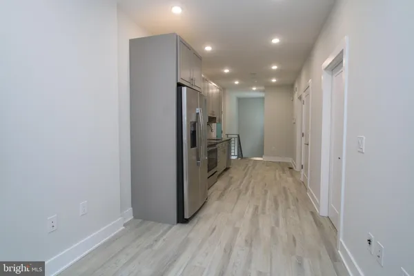 a view of a hallway with wooden floor