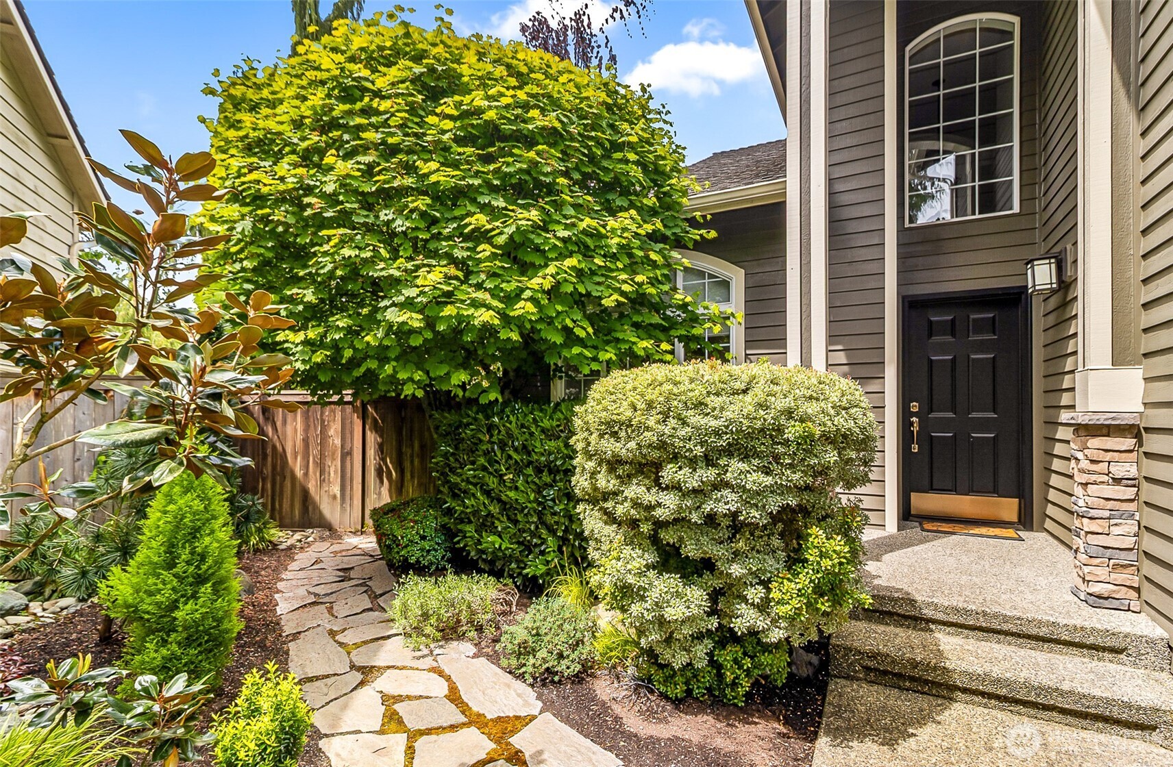 18410 11th Drive Southeast Bothell, WA 98012 - Photo 2 of 40 a plant that is in front of a brick house