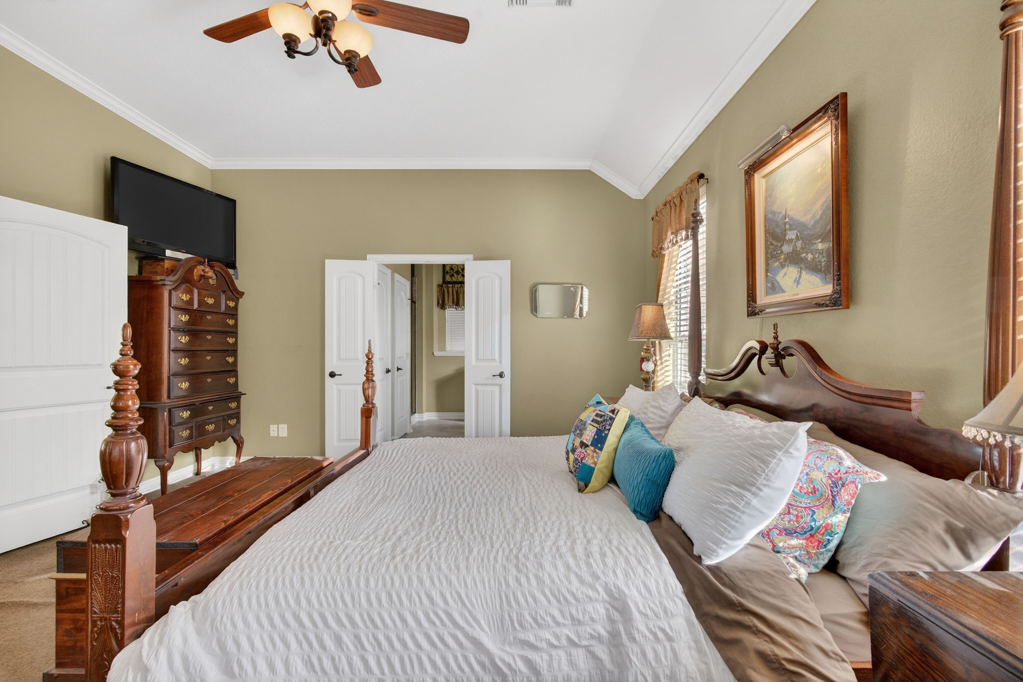 194 Maple Grove Drive Conroe, TX 77384 - Photo 13 of 25 a bedroom with bed and a chandelier