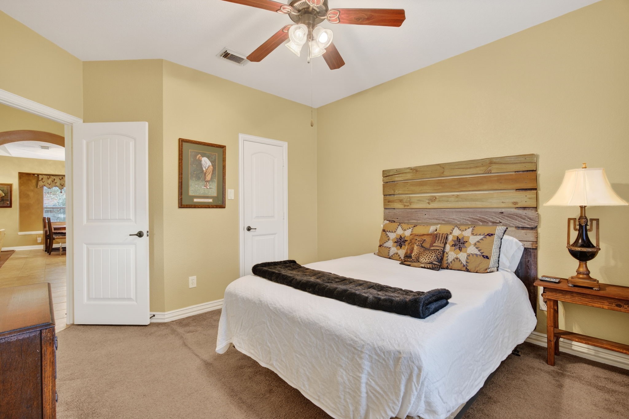 194 Maple Grove Drive Conroe, TX 77384 - Photo 17 of 25 a bedroom with a bed and a chandelier