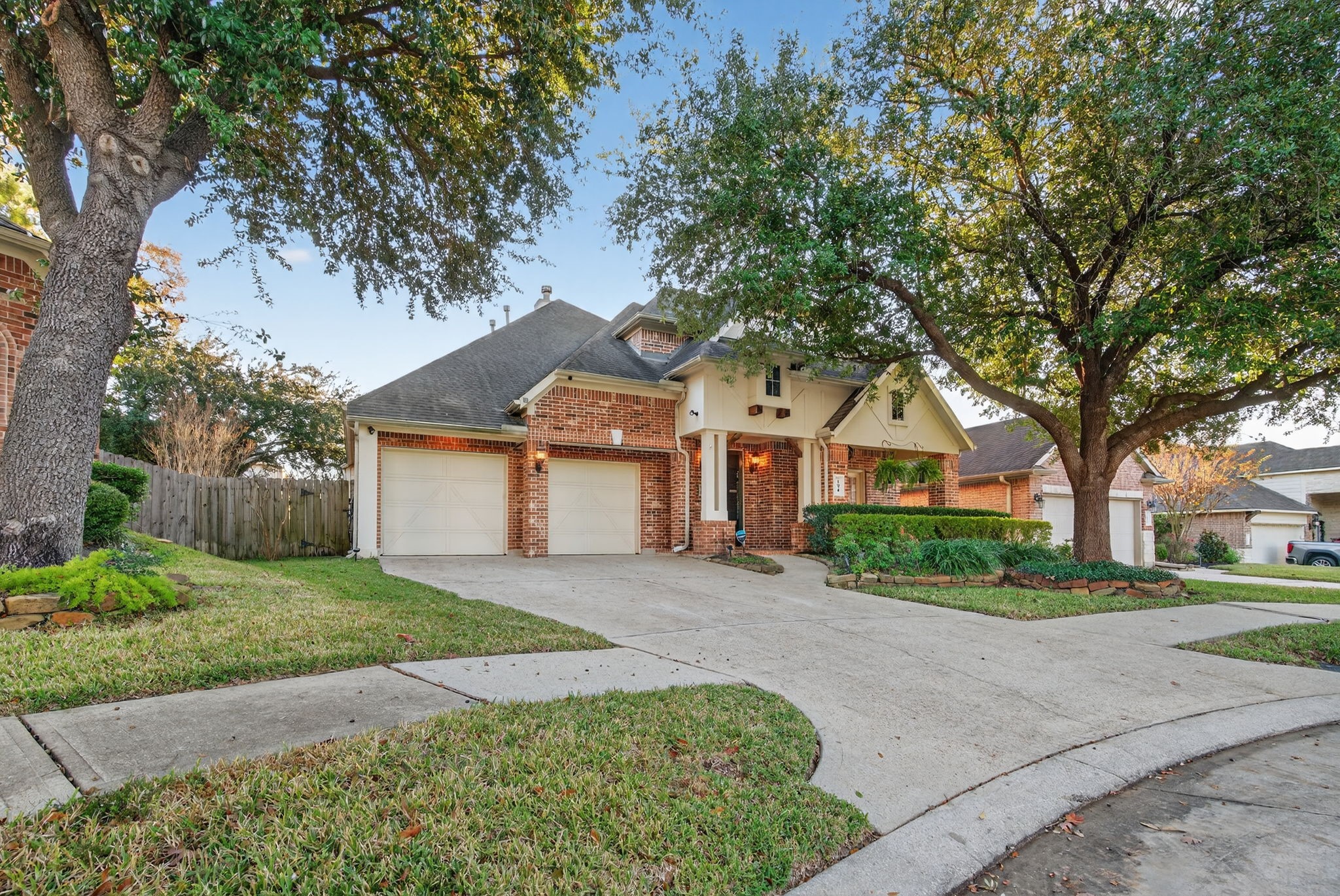 194 Maple Grove Drive Conroe, TX 77384 - Photo 2 of 25 a front view of a house with a garden and trees