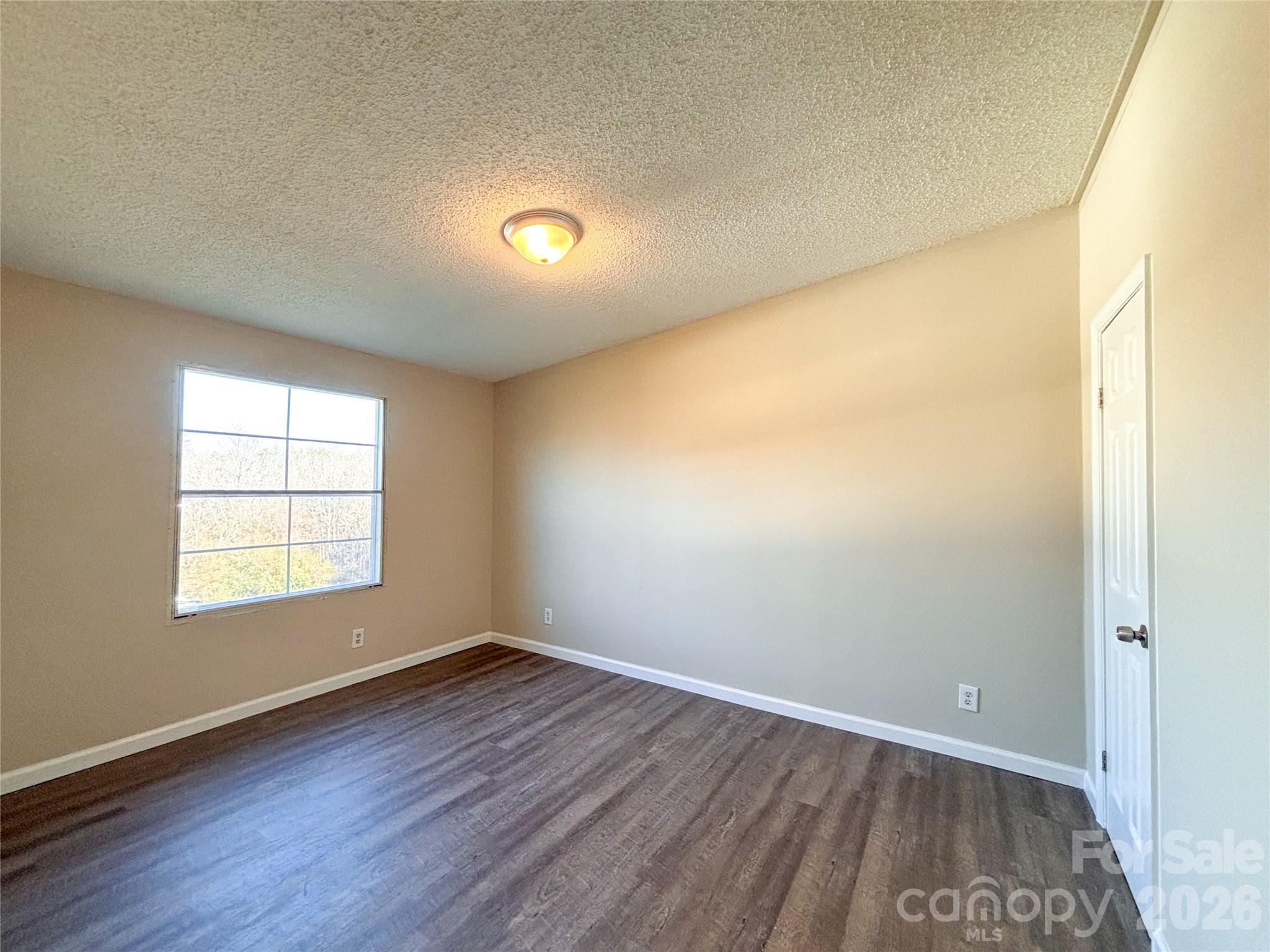 3596 Gull Street Hudson, NC 28638 - Photo 18 of 23 an empty room with wooden floor and windows