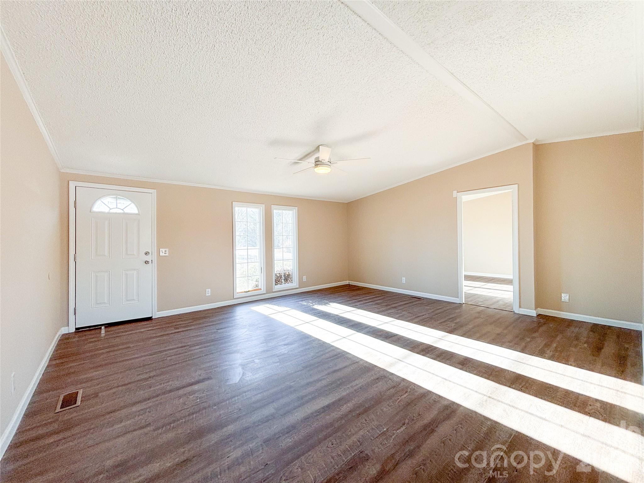 3596 Gull Street Hudson, NC 28638 - Photo 6 of 23 an empty room with wooden floor and windows