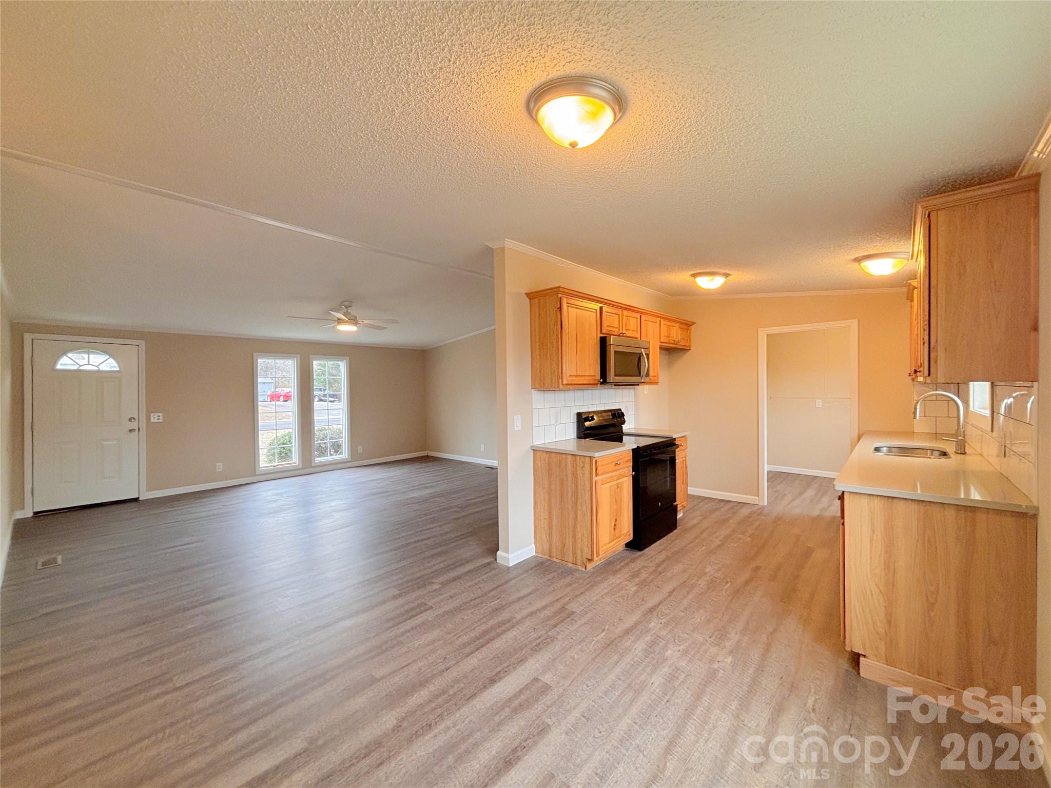 3596 Gull Street Hudson, NC 28638 - Photo 9 of 23 a kitchen with stainless steel appliances a refrigerator and a sink