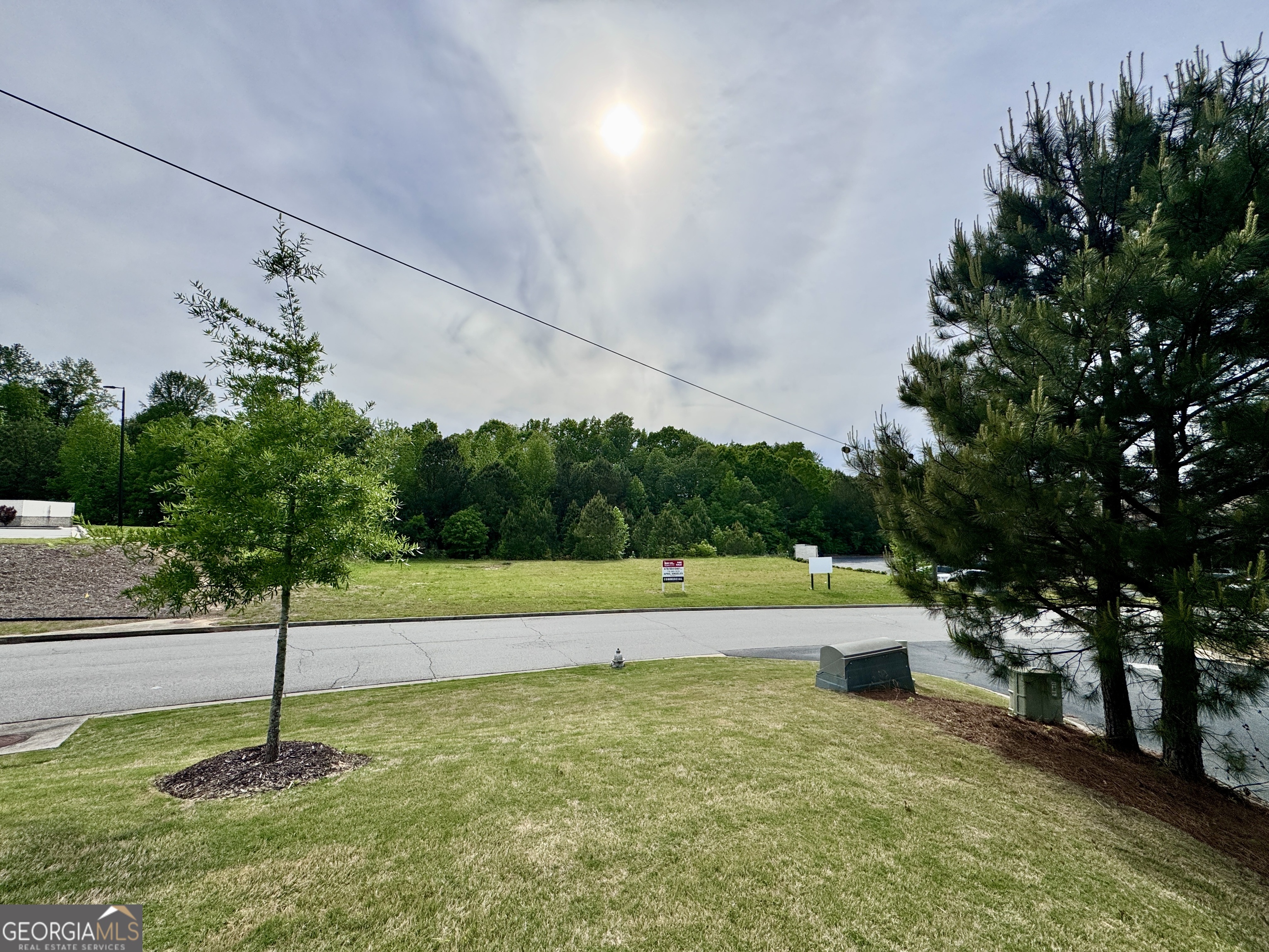 2342 Sparta Way Braselton, GA 30519 - Photo 14 of 25 a green field with lots of trees in the background