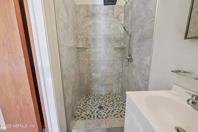 a bathroom with a sink and shower