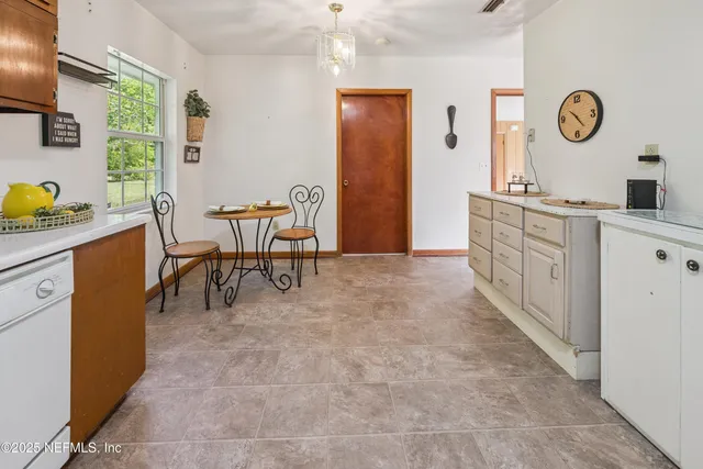 a large kitchen with a table and chairs