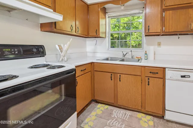 a kitchen with appliances cabinets and a sink