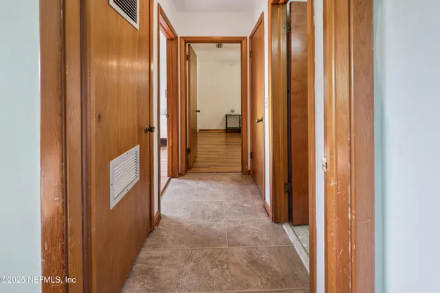a view of a hallway with a wooden door