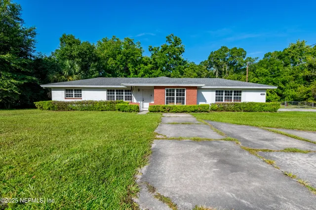 a view of house that has a yard