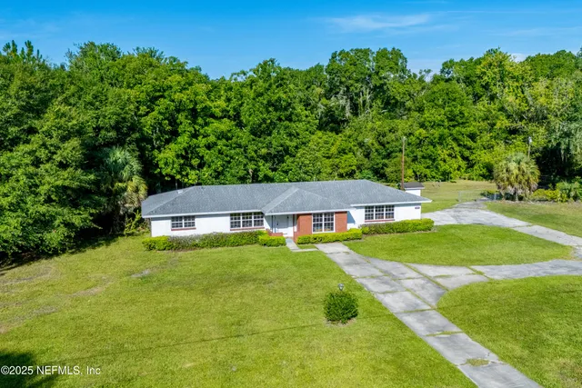 a aerial view of a house with swimming pool and garden view