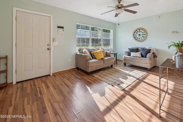 a living room with couch and wooden floor