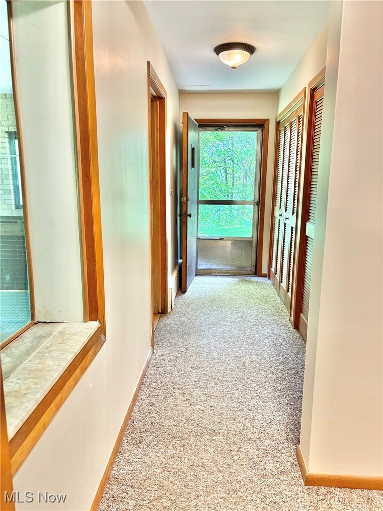 15959 Ridge Road North Royalton, OH 44133 - Photo 43 of 50 Hall leading to indoor pool, 3 double wide storage closets and back patio