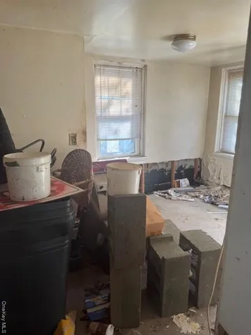 a room with a table chairs and wooden floor