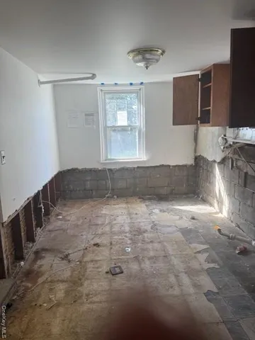 a view of wooden floor and windows in a room