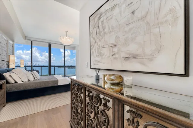 a living room with furniture and a floor to ceiling window