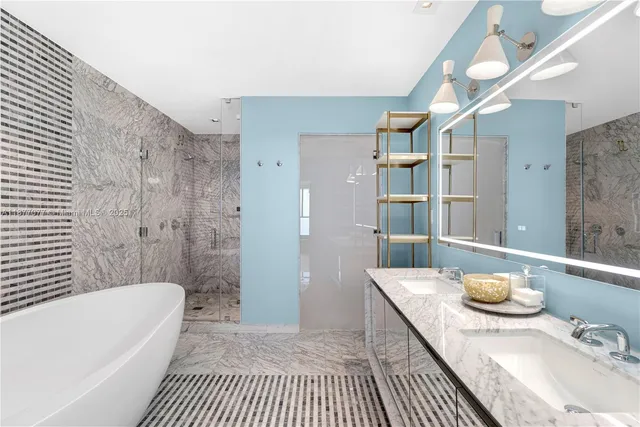 a bathroom with a granite countertop sink a toilet a shower and bathtub