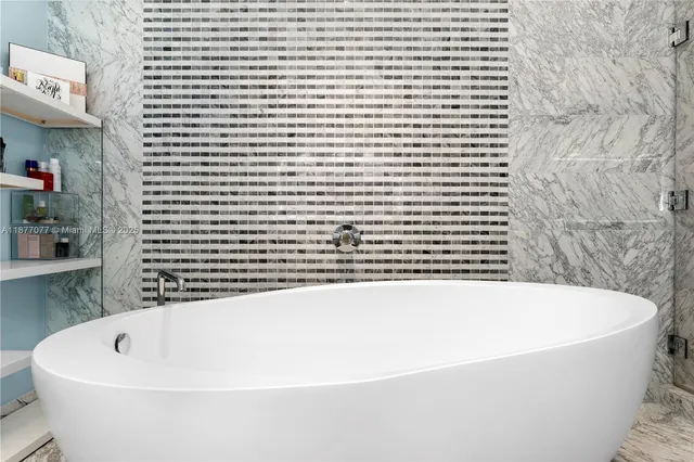 a bathroom with bathtub and shower