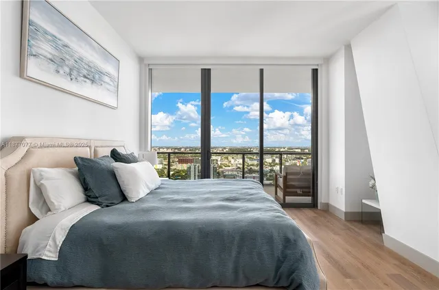 a bedroom with a large bed and a large window