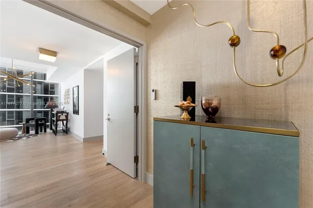 a view of a room with wooden floor and furniture