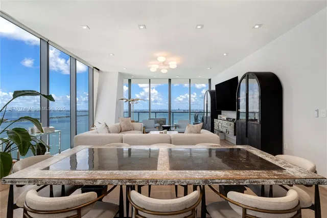 a living room with furniture and a large screen