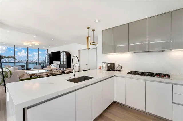 a kitchen with a sink a stove and cabinets