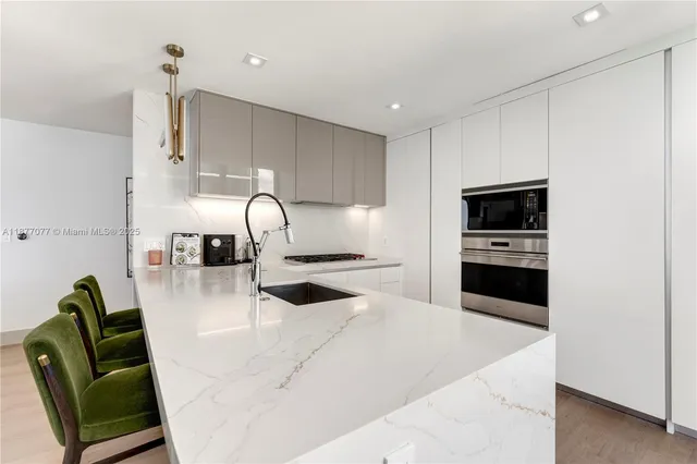 a kitchen with microwave a stove and furniture